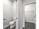 Powder room including modern toilet and leading to walk-in closet with wire shelving at 319 E 16Th St # 302, Indianapolis, IN 46202