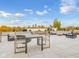 Rooftop deck with outdoor furniture, dining table, and city skyline view at 319 E 16Th St # 302, Indianapolis, IN 46202