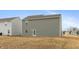Backyard featuring green siding and a door that leads into the home at 3219 E Maygrove Dr, Danville, IN 46122