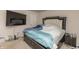 A spacious bedroom featuring a large bed with a decorative headboard and a mounted flat-screen television at 3219 E Maygrove Dr, Danville, IN 46122