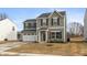 Two-story home featuring green siding, black shutters, a two-car garage and a well-manicured lawn at 3219 E Maygrove Dr, Danville, IN 46122