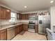 Kitchen featuring stainless steel appliances and brown cabinetry at 3219 E Maygrove Dr, Danville, IN 46122