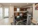 Kitchen with stainless steel appliances, brown cabinets and a dining table with gray chairs at 3219 E Maygrove Dr, Danville, IN 46122