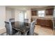 Eat-in kitchen featuring stainless steel appliances, dining table with 4 chairs, custom cabinets, and a window view at 3219 E Maygrove Dr, Danville, IN 46122