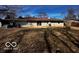 The home's back exterior is well-lit with a patio area and satellite dish at 3337 Nottingham Dr, Columbus, IN 47203