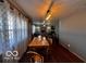 Open floor plan showcasing dining area, living room, and hardwood floors at 3337 Nottingham Dr, Columbus, IN 47203