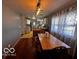 Cozy dining area with hardwood floors and a large window for natural light at 3337 Nottingham Dr, Columbus, IN 47203