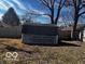 Backyard shed featuring wood exterior and mounted ladder at 3337 Nottingham Dr, Columbus, IN 47203