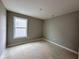 Cozy bedroom with a neutral paint color, carpeted flooring, and a window at 335 Atlas Dr, Lebanon, IN 46052