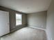 Neutral colored room with carpeted floors, one window and a door at 335 Atlas Dr, Lebanon, IN 46052