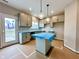 Bright kitchen with grey cabinets, a center island, stainless appliances and a door to the outside at 335 Atlas Dr, Lebanon, IN 46052