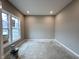 Home office space with neutral colored walls and natural lighting from the windows at 335 Atlas Dr, Lebanon, IN 46052