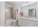 Bathroom featuring shower over tub, neutral walls and vanity with cabinet at 355 E Ohio E St # 206, Indianapolis, IN 46204