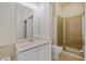 Bathroom featuring walk-in shower with glass door, neutral color scheme, and tile floors at 355 E Ohio E St # 206, Indianapolis, IN 46204