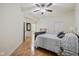 Bright bedroom with ceiling fan, neutral walls, wood floor, and modern gray bedding at 355 E Ohio E St # 206, Indianapolis, IN 46204