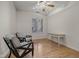 Bedroom featuring neutral walls, ceiling fan, wood floors, and work desk at 355 E Ohio E St # 206, Indianapolis, IN 46204