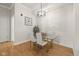 Cozy dining area featuring a modern chandelier and a glass table that complements the hardwood flooring at 355 E Ohio E St # 206, Indianapolis, IN 46204