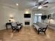 Bright living room featuring a fireplace, ceiling fan, and access to a balcony at 355 E Ohio E St # 206, Indianapolis, IN 46204