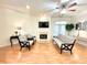 Bright living room featuring a fireplace, ceiling fan, and access to a balcony at 355 E Ohio E St # 206, Indianapolis, IN 46204