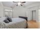 Cozy bedroom featuring a ceiling fan, hardwood floors, and balcony access, perfect for relaxation at 355 E Ohio E St # 206, Indianapolis, IN 46204