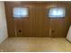 The basement room features wood paneling and a window with curtains at 4107 E 37Th St, Anderson, IN 46017