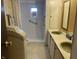 Modest bathroom featuring a shower, double sinks, and storage at 4107 E 37Th St, Anderson, IN 46017