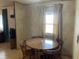 Quaint dining area with a round wood table set and a window for natural light at 4107 E 37Th St, Anderson, IN 46017