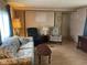 Cozy living room showcasing natural light, a comfortable sofa, and a recliner at 4107 E 37Th St, Anderson, IN 46017