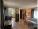 A bright living room featuring wood floors, a printed sofa and a view into the kitchen at 4107 E 37Th St, Anderson, IN 46017