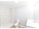 Modern bathroom featuring a tiled shower, new toilet, and sleek white vanity with ample counter space at 4123 S Lynhurst Dr, Indianapolis, IN 46221