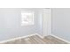 Bright bedroom boasts a window, large closet, and modern light-colored floors at 4123 S Lynhurst Dr, Indianapolis, IN 46221