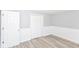 A cozy bedroom with an open door, modern floor, and a large closet at 4123 S Lynhurst Dr, Indianapolis, IN 46221