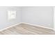 Bedroom featuring laminate flooring and a window with a view of the surrounding area at 4123 S Lynhurst Dr, Indianapolis, IN 46221