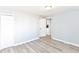 Light-filled bedroom with modern floors, closet, and access to the kitchen at 4123 S Lynhurst Dr, Indianapolis, IN 46221