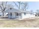Exterior view of home with neutral vinyl siding, a covered porch and a detached two car garage at 4123 S Lynhurst Dr, Indianapolis, IN 46221