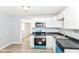 Updated kitchen featuring modern appliances, white cabinetry and updated laminate flooring at 4123 S Lynhurst Dr, Indianapolis, IN 46221