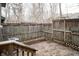 Backyard features a wooden fence, brick wall, and wood patio at 4264 Foxglove Trce, Indianapolis, IN 46237