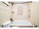Tiled bathtub featuring shower head and tiled walls with a decorative center piece at 4264 Foxglove Trce, Indianapolis, IN 46237