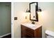 Bathroom vanity features a modern sink, wood cabinets, and decorative lighting at 4264 Foxglove Trce, Indianapolis, IN 46237