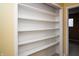 Walk-in closet with multiple white shelves for clothing or storage at 4264 Foxglove Trce, Indianapolis, IN 46237