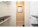 Walk-in closet featuring shelving, neutral carpet and a window for natural light at 4264 Foxglove Trce, Indianapolis, IN 46237