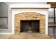Close up on a stone fireplace with white mantel at 4264 Foxglove Trce, Indianapolis, IN 46237