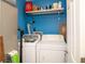 Laundry room with washer, dryer, shelf and blue painted walls at 4264 Foxglove Trce, Indianapolis, IN 46237