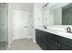 Bathroom with double vanity featuring dark cabinets, white countertops, and a separate shower area at 4408 W Preserve Pass, New Palestine, IN 46163