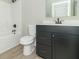 Well-lit bathroom featuring a black vanity with a white countertop and a shower-tub combination at 4408 W Preserve Pass, New Palestine, IN 46163