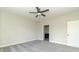 Carpeted bedroom with ceiling fan showcases an adjoining bathroom, adding convenience and privacy at 4408 W Preserve Pass, New Palestine, IN 46163