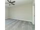 An empty, carpeted bedroom is well-lit and features a ceiling fan and a closed, white door at 4408 W Preserve Pass, New Palestine, IN 46163
