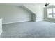 Spacious bonus room with large window, gray carpet, and neutral walls offering versatile space at 4408 W Preserve Pass, New Palestine, IN 46163