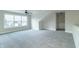 Upstairs bonus room with soft carpet, lots of light from a large window, and neutral gray paint at 4408 W Preserve Pass, New Palestine, IN 46163