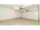 A spacious garage with a concrete floor and a white garage door at 4408 W Preserve Pass, New Palestine, IN 46163